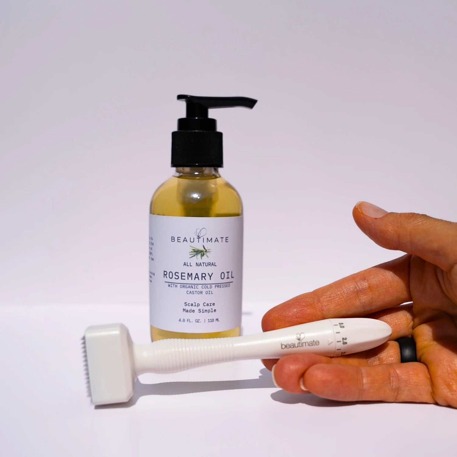 woman holding derma stamp with a bottle of rosemary hair growth serum