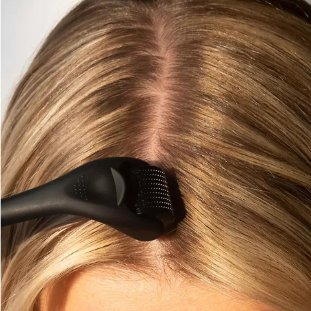woman using derma roller on hair scalp hair