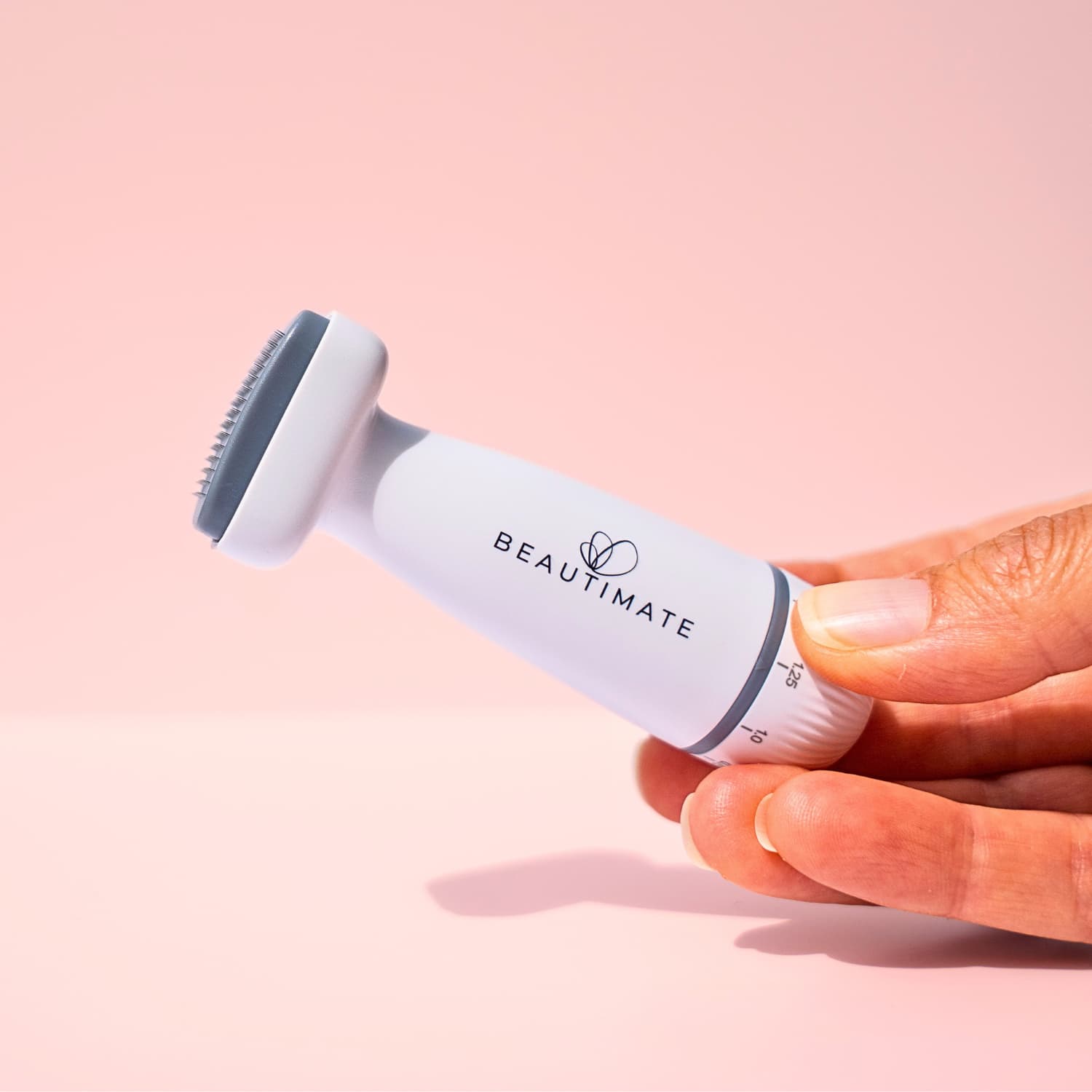 Woman using Beautimate 120-pin derma stamp for smoother, brighter skin