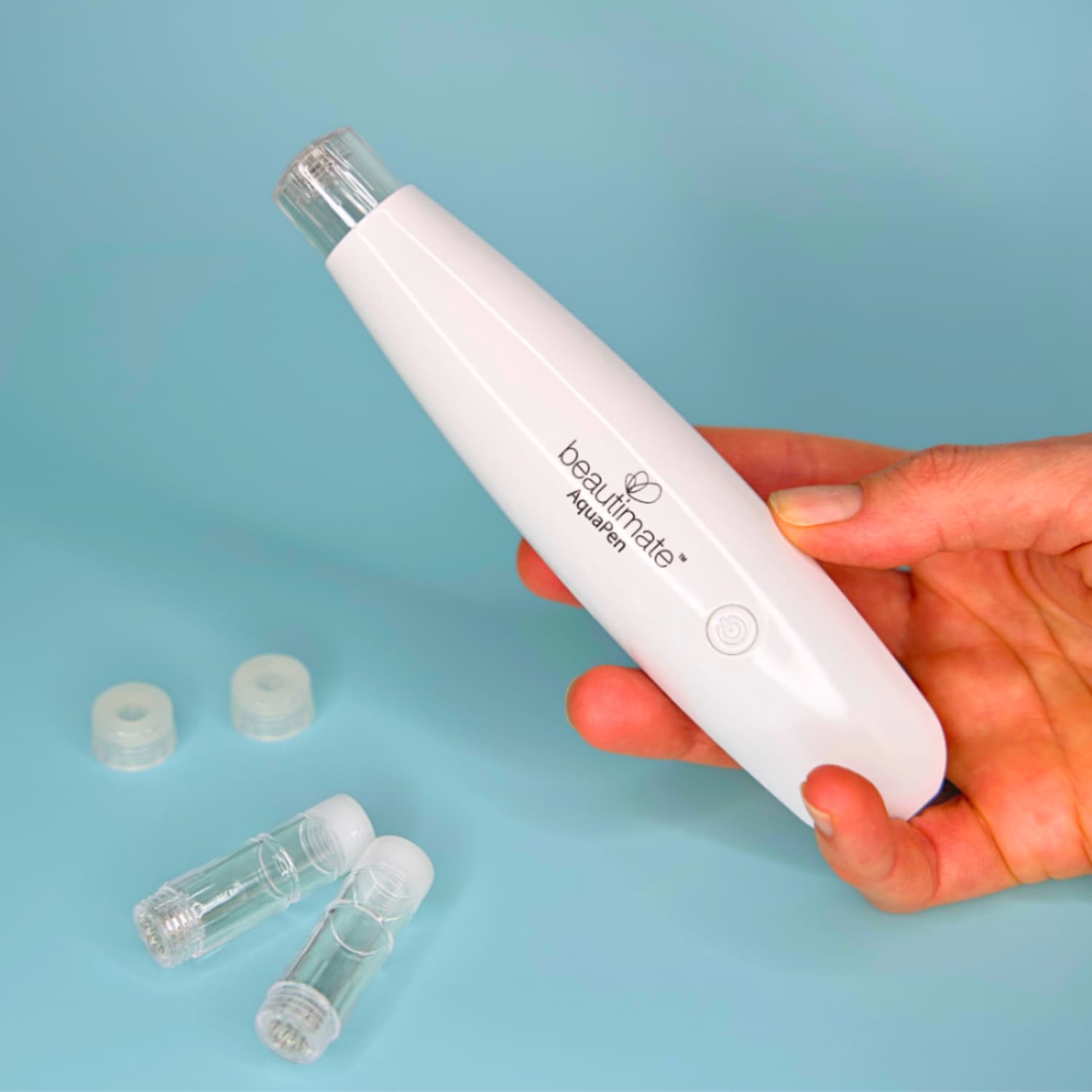 Hand holding Aqua Hydra Pen during skincare routine