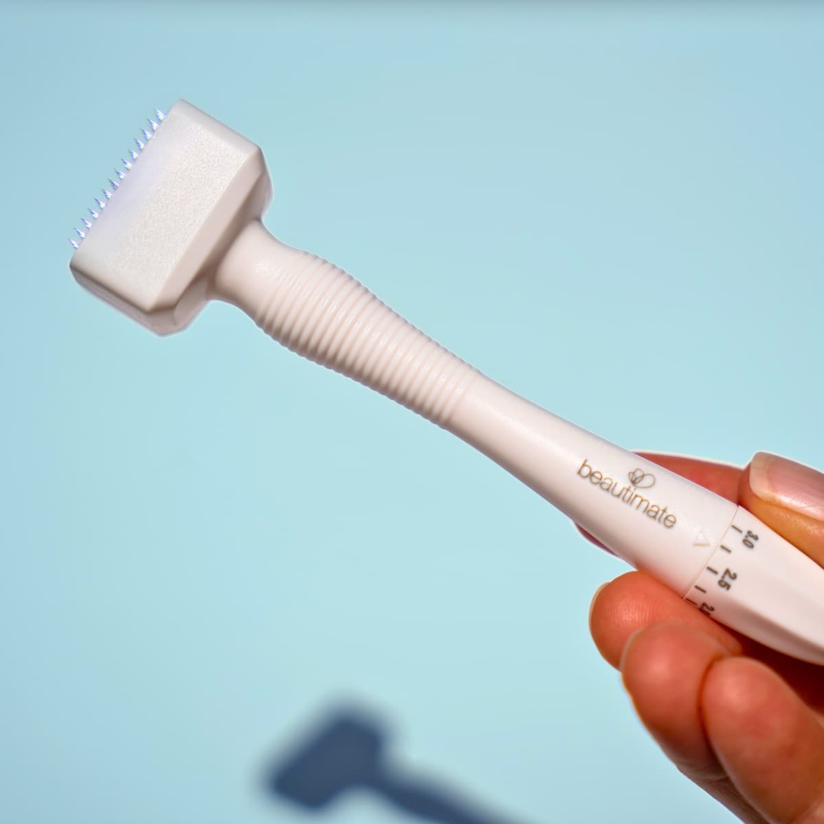 Ergonomic design of Beautimate Derma Stamp shown in hand for size and grip demonstration