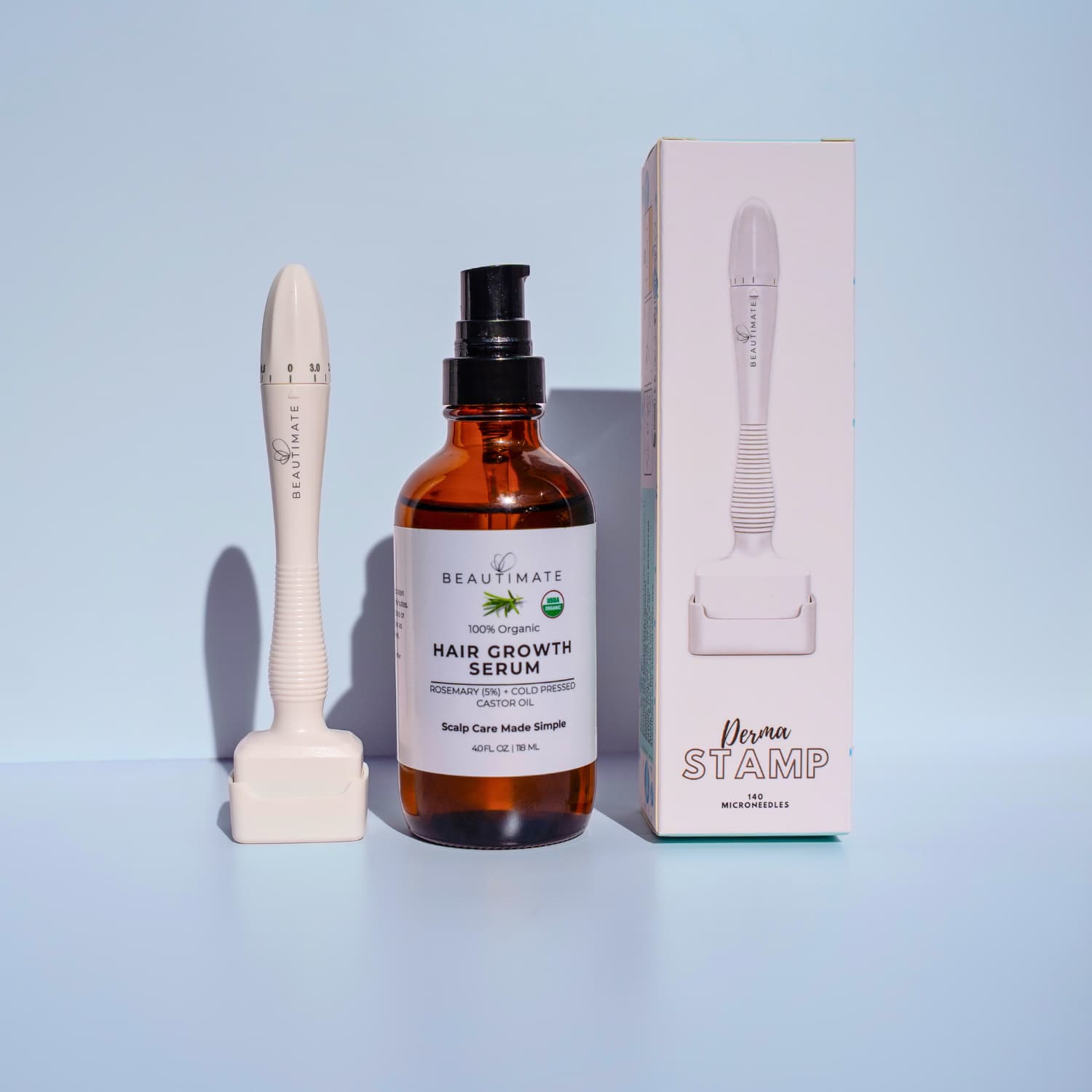 Hair growth serum bottle with derma stamp applicator and beautimate box on a light blue background