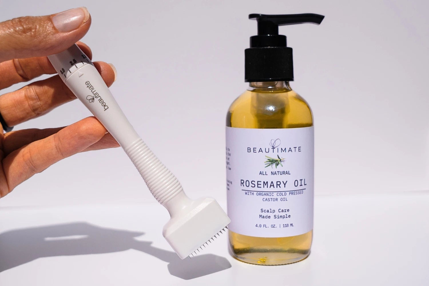 beautimate rosemary oil and hand holding dermastamp 