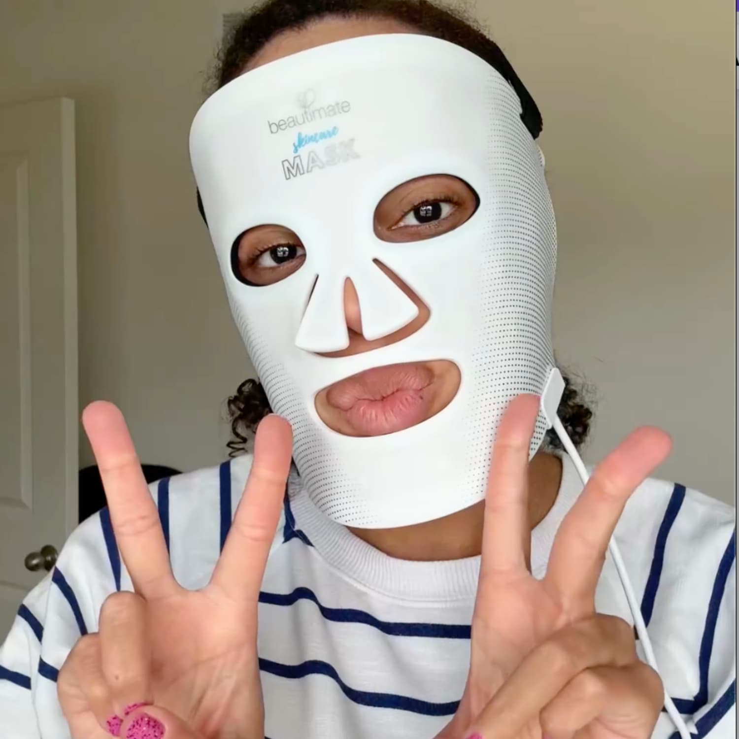 Woman using Beautimate LED light therapy mask for wrinkles and skin firming at home