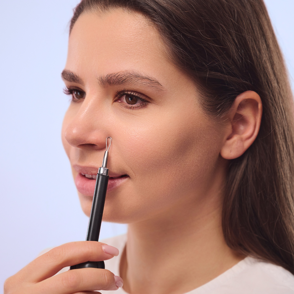woman using pore extractor
