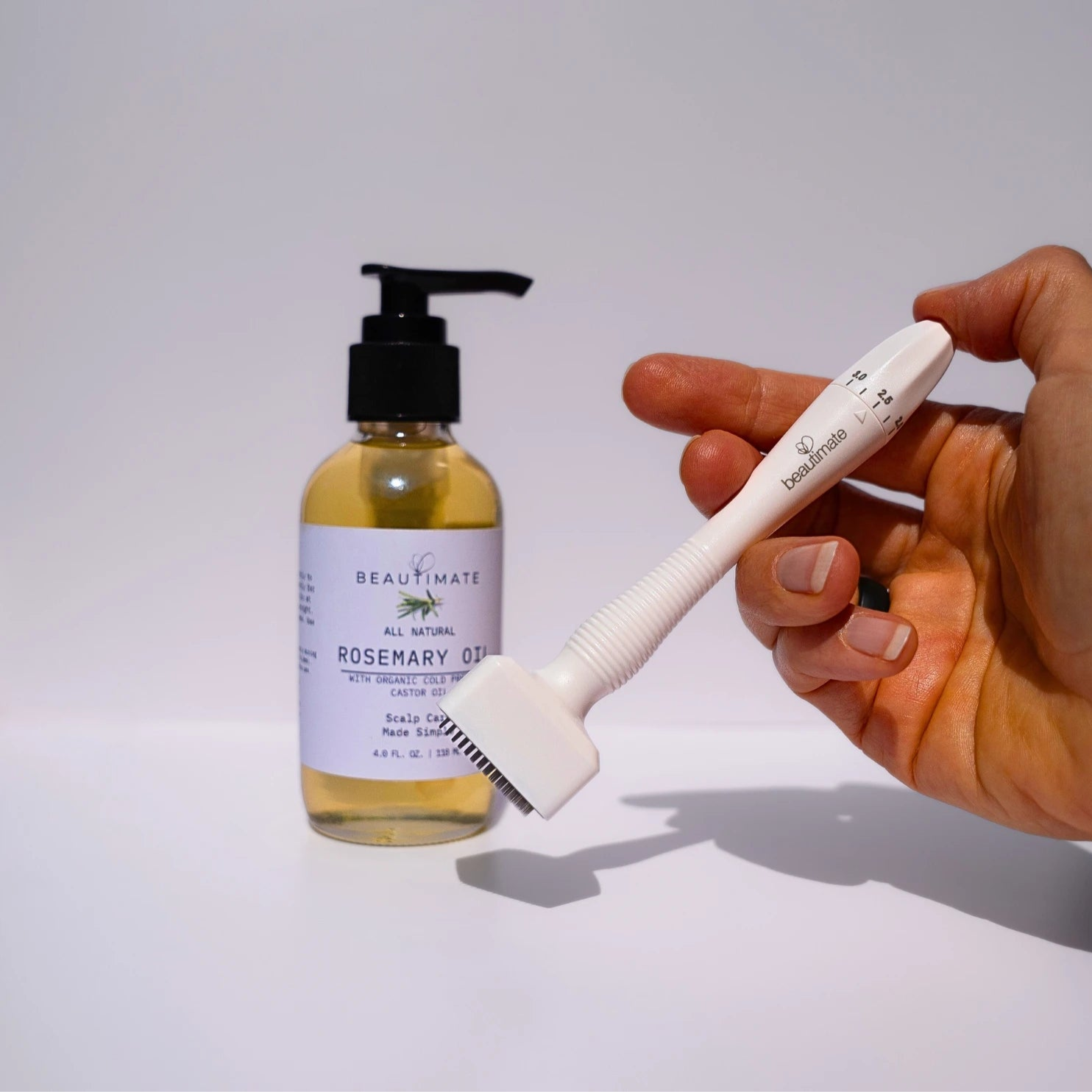 microneedle derma stamp with rosemary oil in the background
