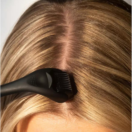 woman using derma roller on hair scalp hair