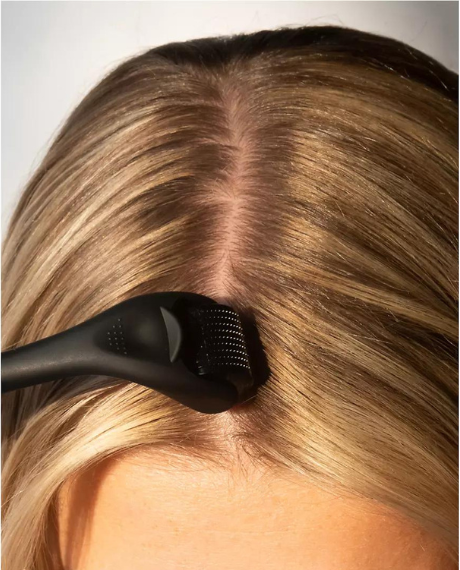 woman using derma roller on hair scalp hair