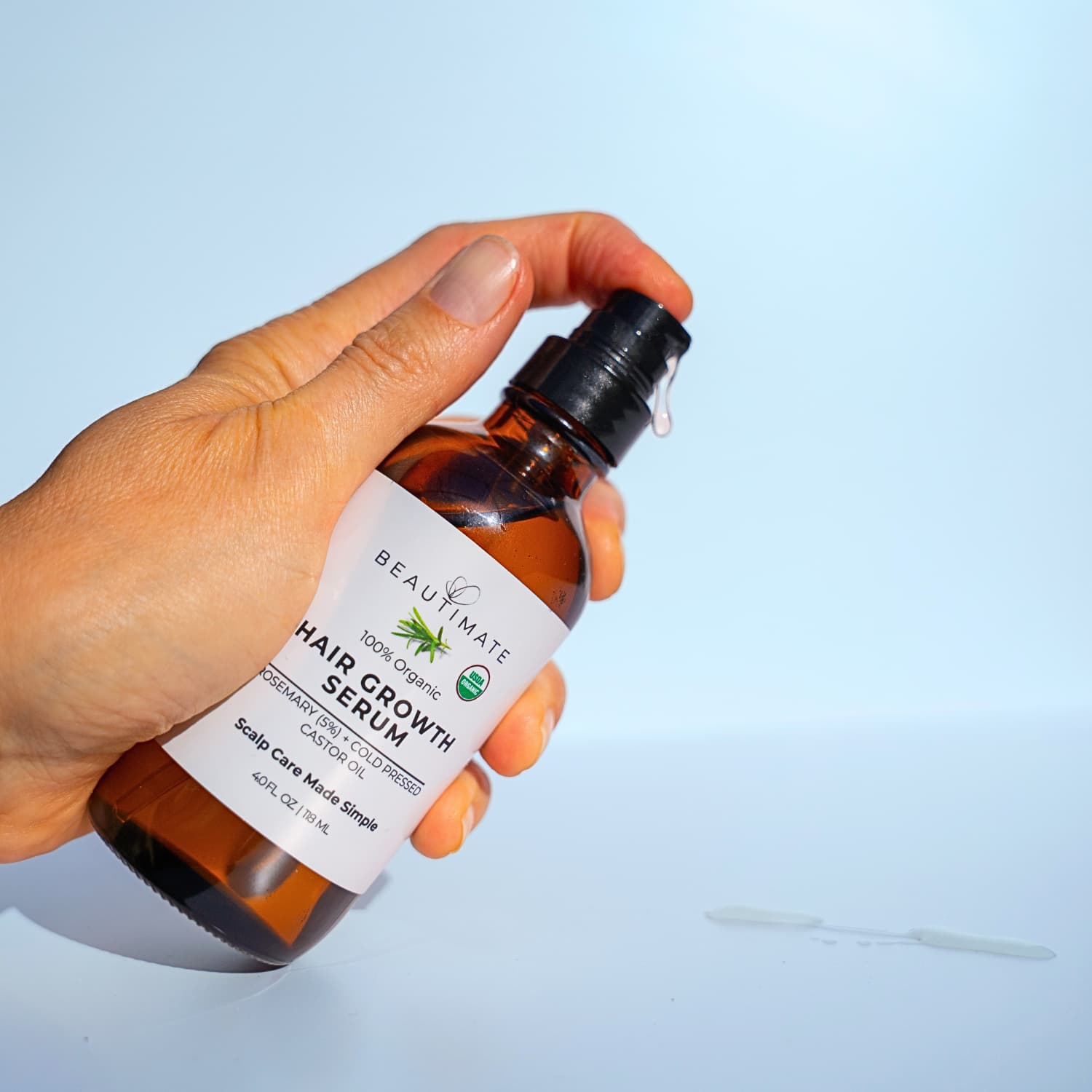 Beautimate organic rosemary and castor oil scalp serum in amber bottle