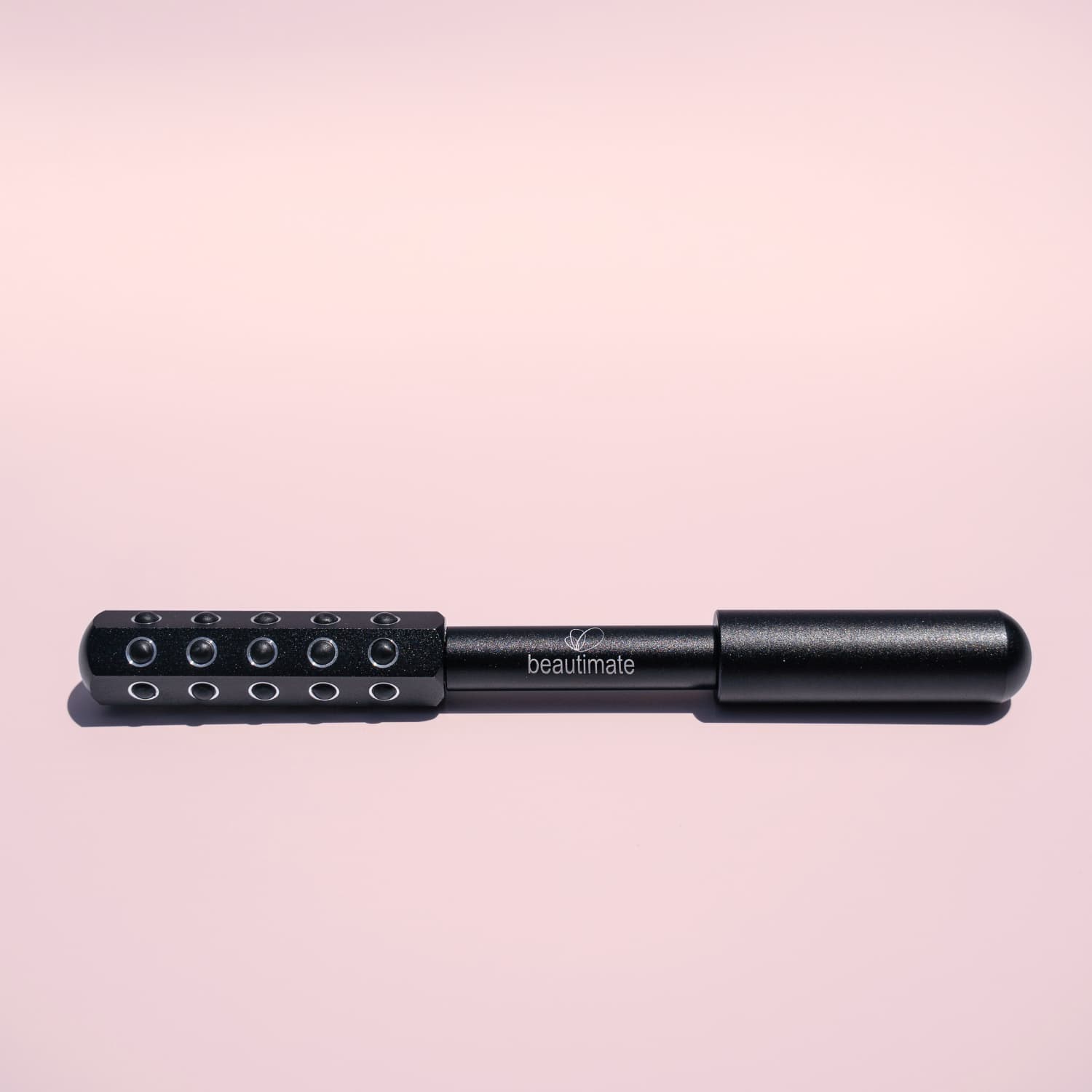 germanium roller on pink background
