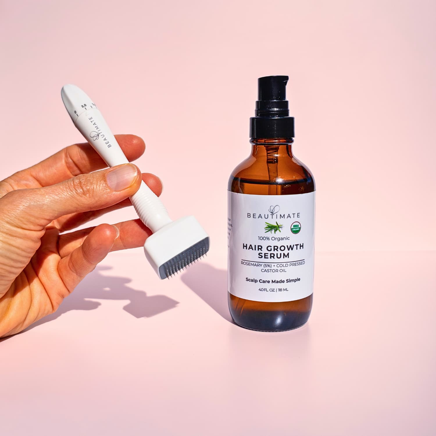 Hand holding a derma stamp with rosemary oil for hair growth 