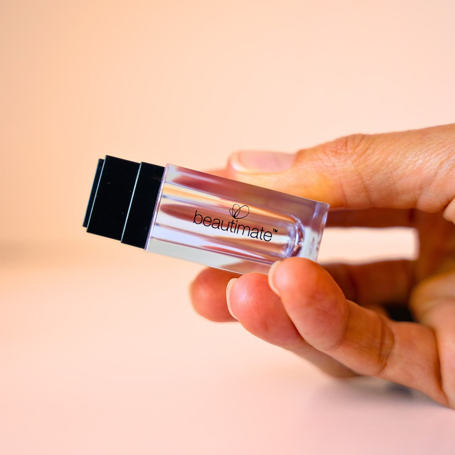 Beautimate Hydra Stamp held in hand to show compact size and ergonomic grip