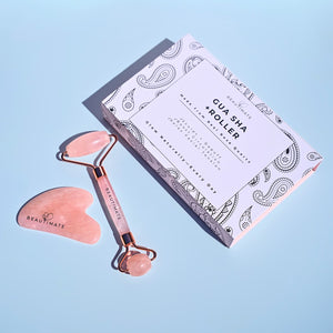 Genuine rose quartz facial roller with smooth stone handle designed for facial massage and skincare routines with the decorative box