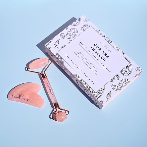 Genuine rose quartz facial roller with smooth stone handle designed for facial massage and skincare routines with the decorative box