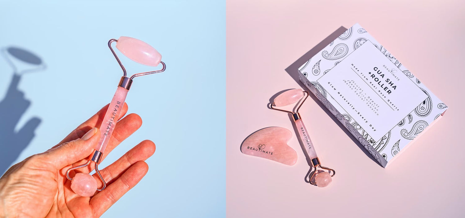 Rose quartz jade roller held by a hand with packaging and instructions on a light pink background by beautimate