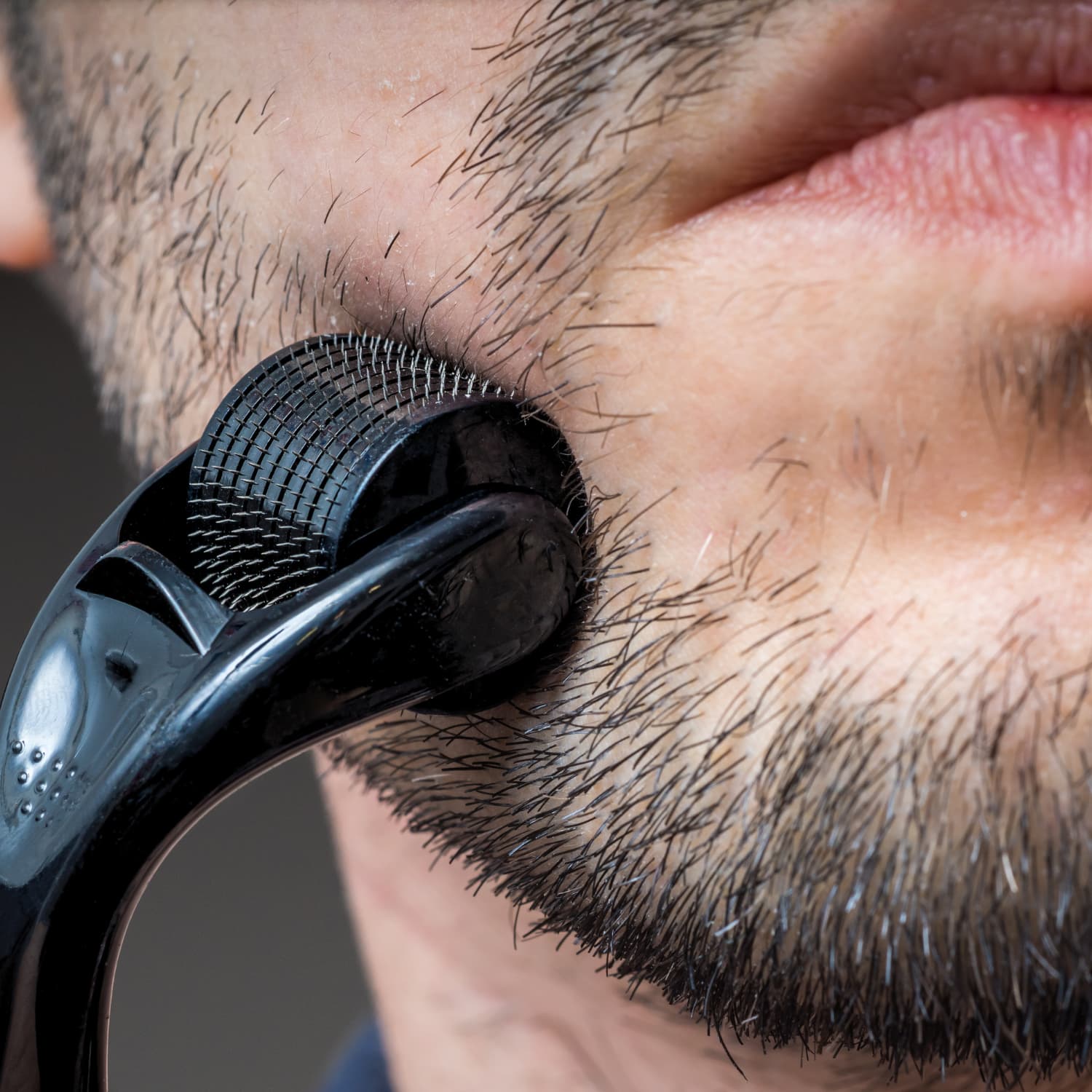 man using Beautimate Microneedle Derma Roller for at-home skincare