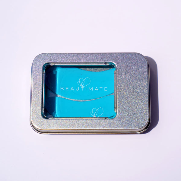 Reusable silicone eye patches stored inside the included metal tin.