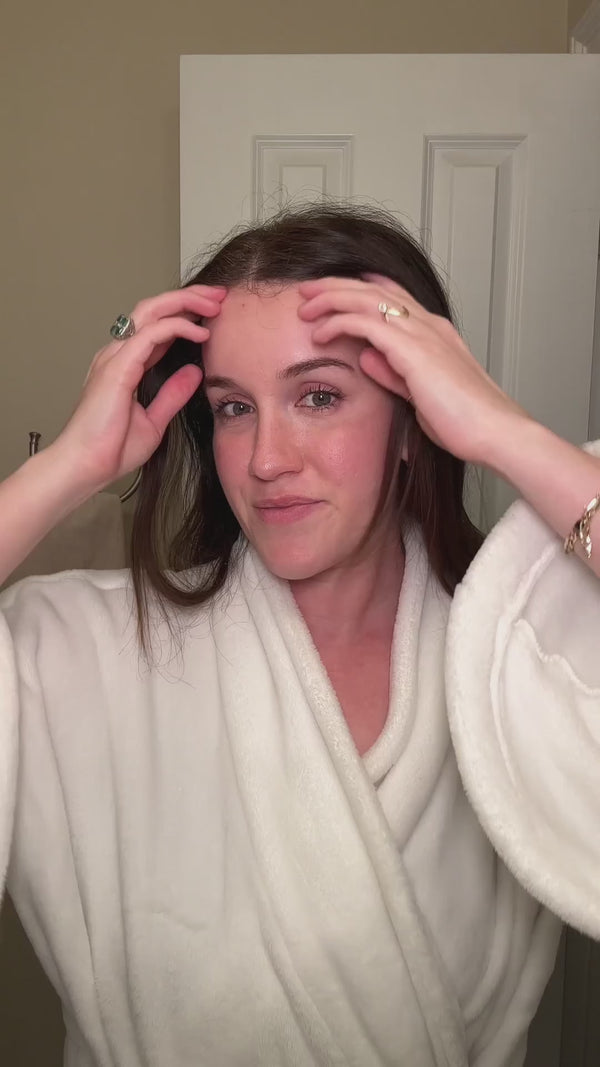 Woman using the Beautimate Derma Stamp and Rosemary Oil on her scalp