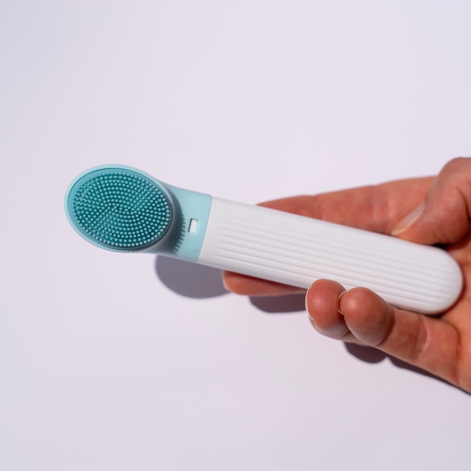 Detail view of silicone face cleaning brush included in 10-in-1 skincare set