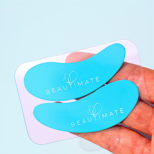 Applying reusable silicone eye patch under eye to reduce puffiness and lock in serum