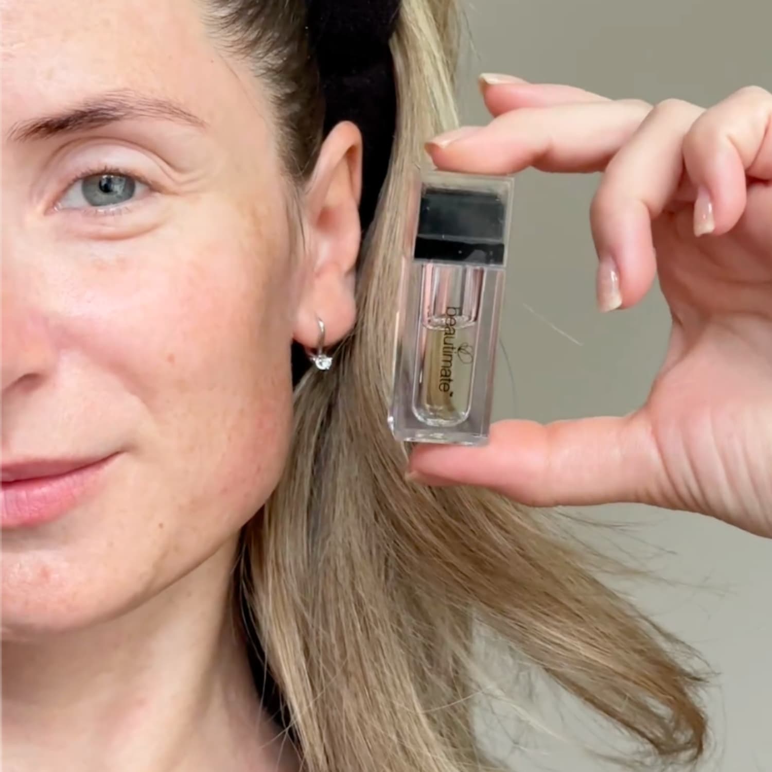 woman holding Hydra Stamp titanium needle configuration for safe home use
